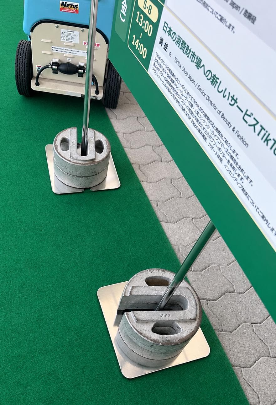 Cast iron weights supporting temporary signage
