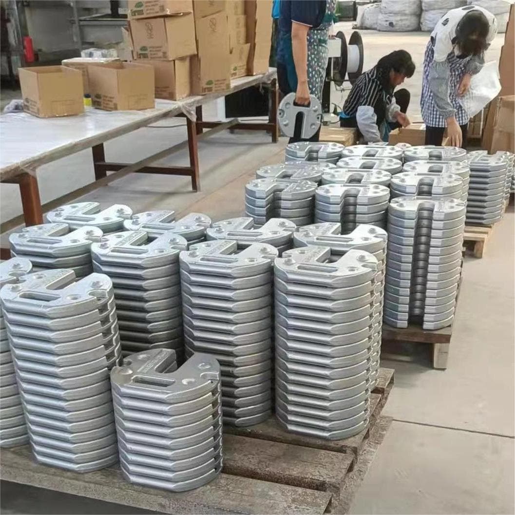 Stacked silver-gray cast iron weights prepared in batches