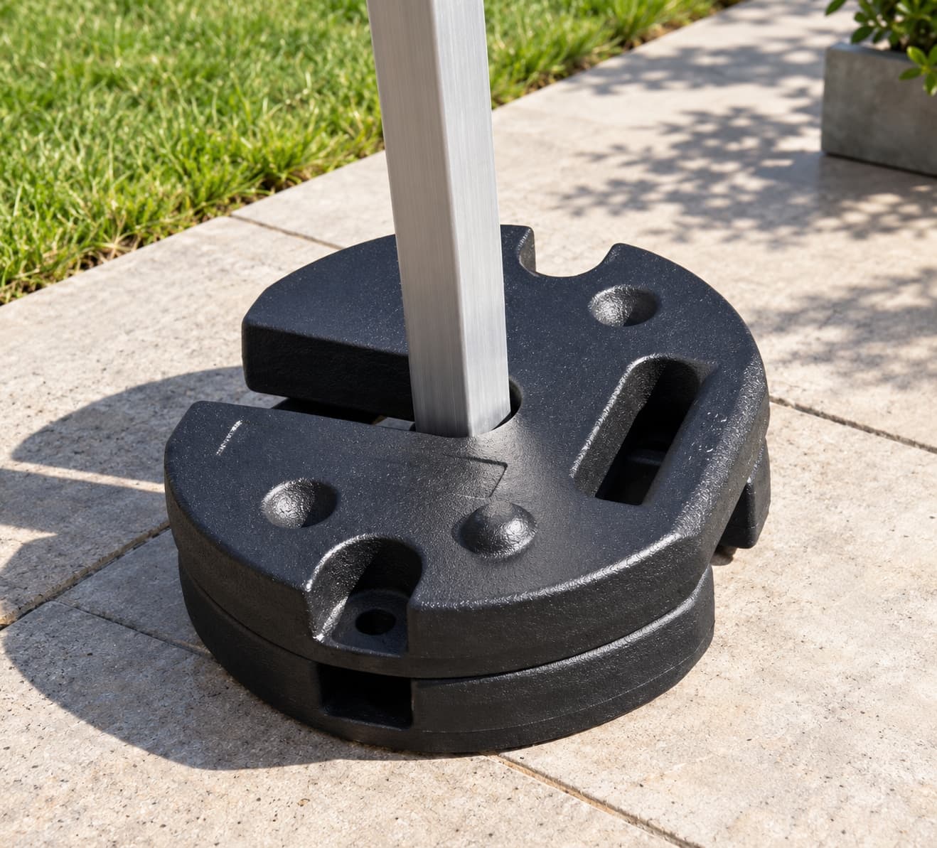 Stacked black cast iron tent weights installed around a canopy leg