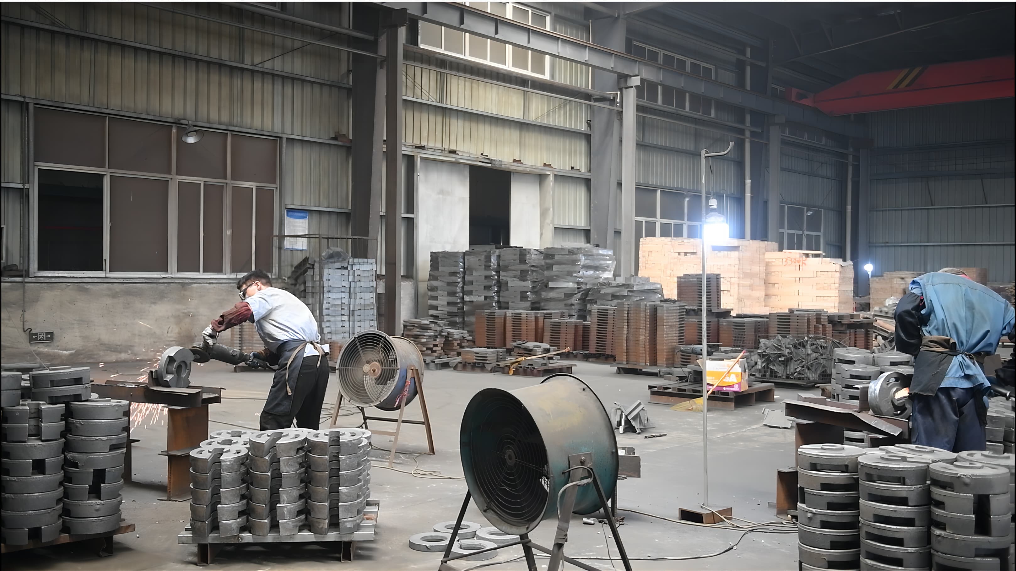 Workers grinding and finishing cast iron tent weights