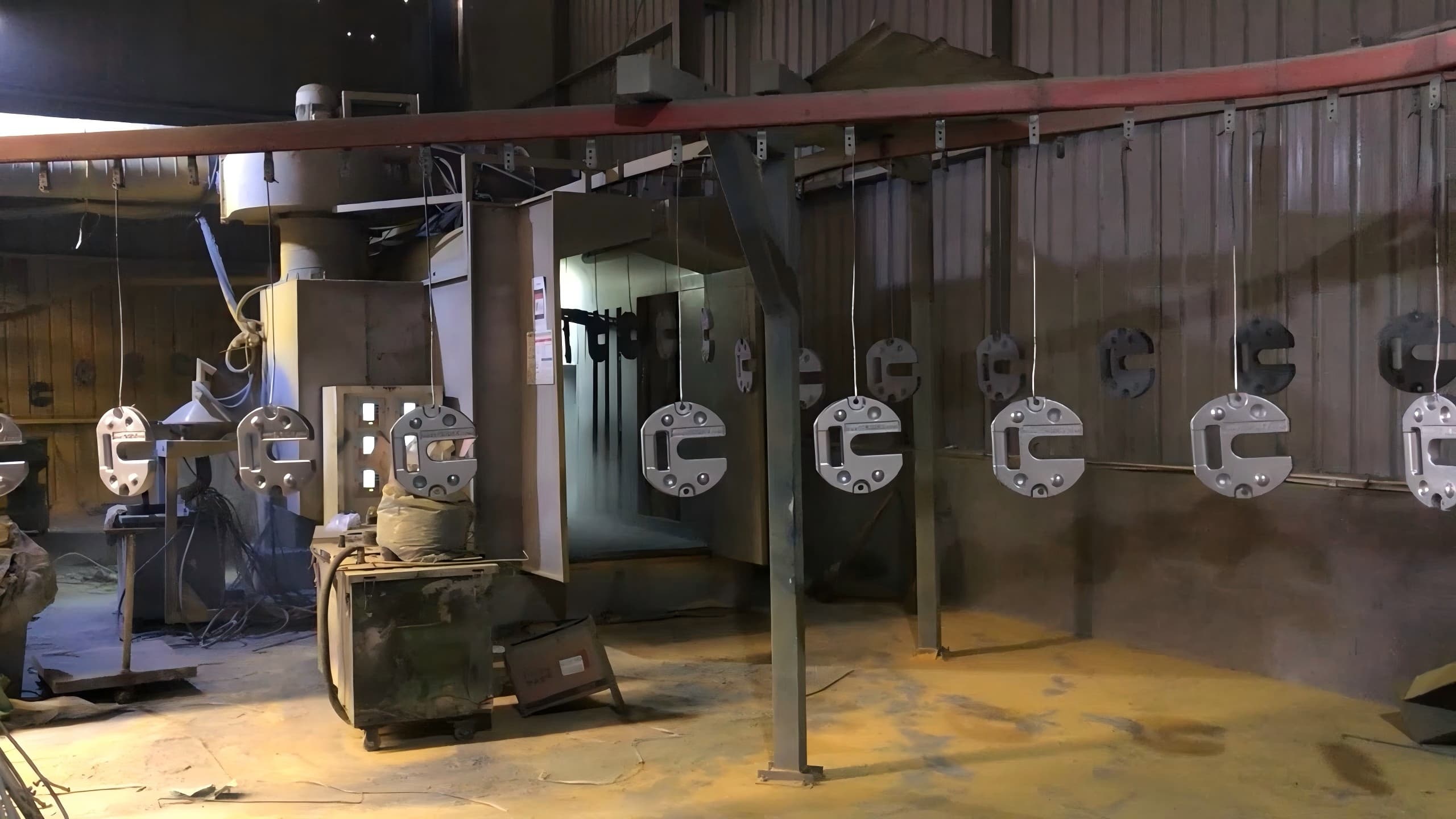 Cast iron tent weights on a surface treatment line